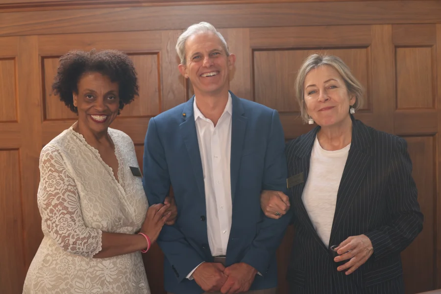 Two attendees pose together with the Distinguished Faculty Lecturer