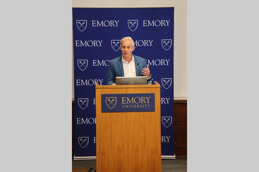 The 2026 Distinguished Faculty Lecturer speaks at the Emory podium"